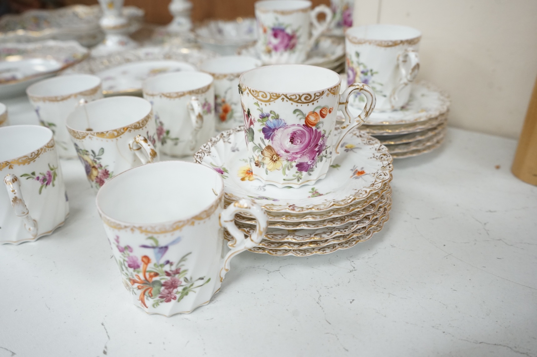 A Dresden porcelain part tea set together with reticulated side plates, largest 26cm in diameter